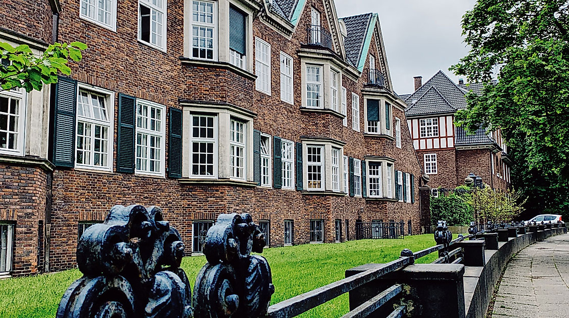 Backsteinhäuser mit weißen Fensterläden und Skulpturen in Hamburg Eppendorf