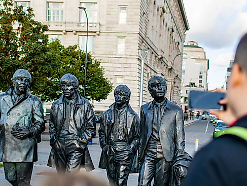 The Beatles statue with visitor