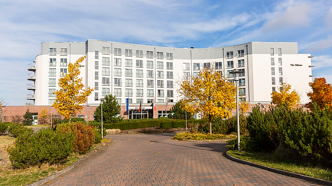 Hotel Rilano Hamburg mit heller Fassade und herbstlicher Gartenanlage an der Elbe