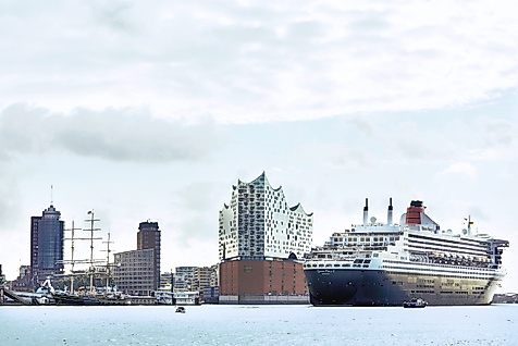 Queen Mary 2 fährt in den Hamburger Hafen ein, im Hintergrund die Elbphilharmonie und Skyline