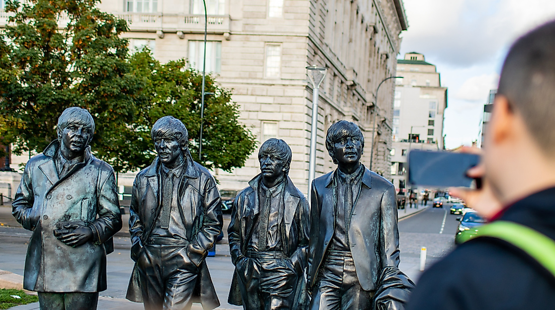 The Beatles statue with visitor