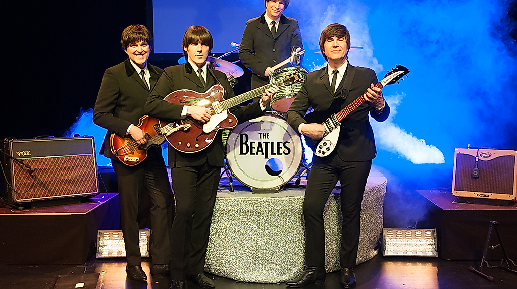 Beatles Band auf der Bühne mit Instrumenten