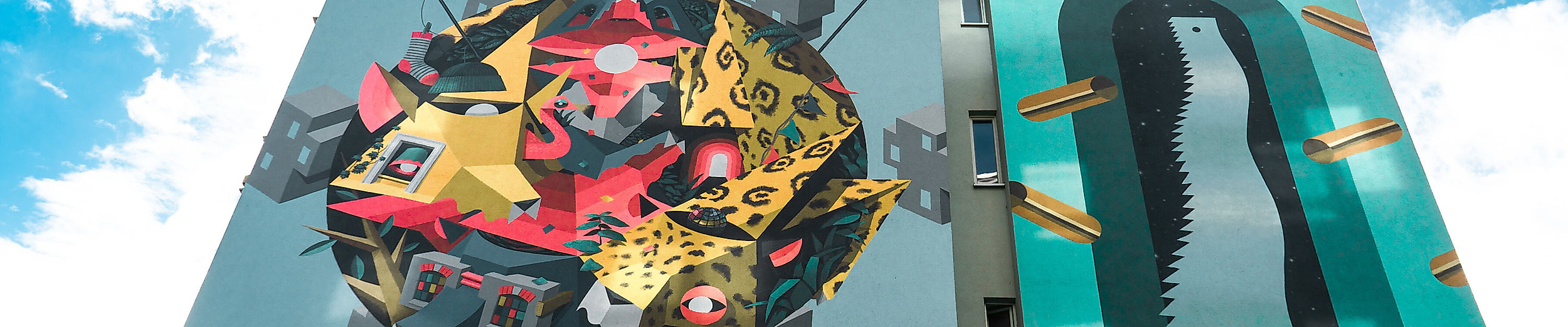 Großflächige Street-Art-Fassade im Gängeviertel Hamburg mit bunten Motiven auf modernem Gebäude